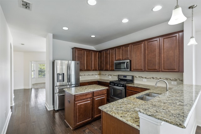 kitchen featuring sink, kitchen peninsula, hanging light fixtures, appliances with stainless steel finishes, and dark hardwood / wood-style flooring