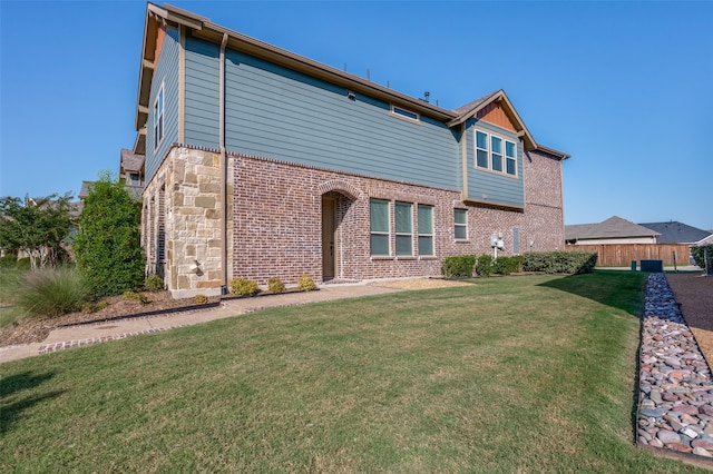 rear view of property with a lawn