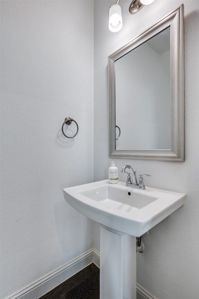 bathroom with hardwood / wood-style floors and sink