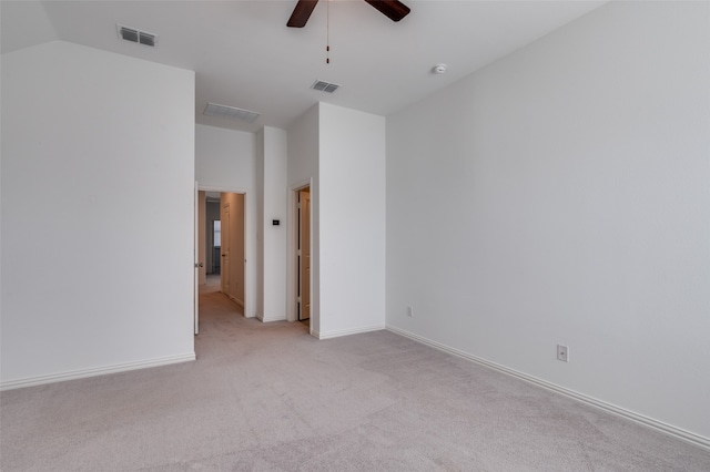 carpeted empty room with ceiling fan and lofted ceiling