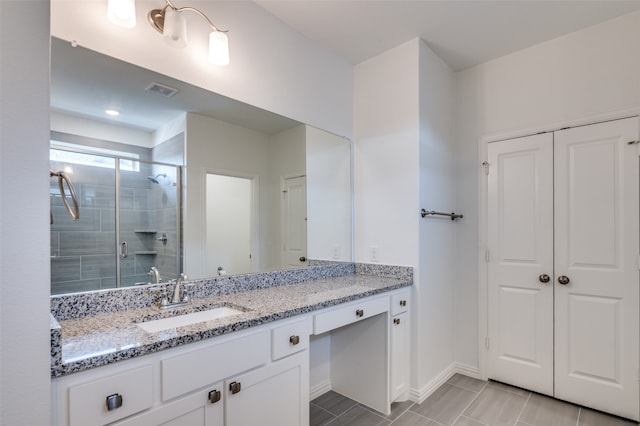 bathroom with walk in shower and vanity