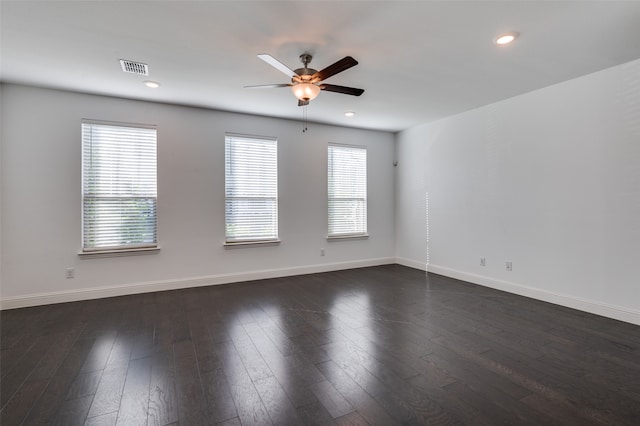 spare room with ceiling fan, plenty of natural light, and dark hardwood / wood-style flooring