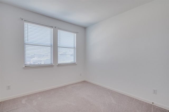 unfurnished room with light carpet