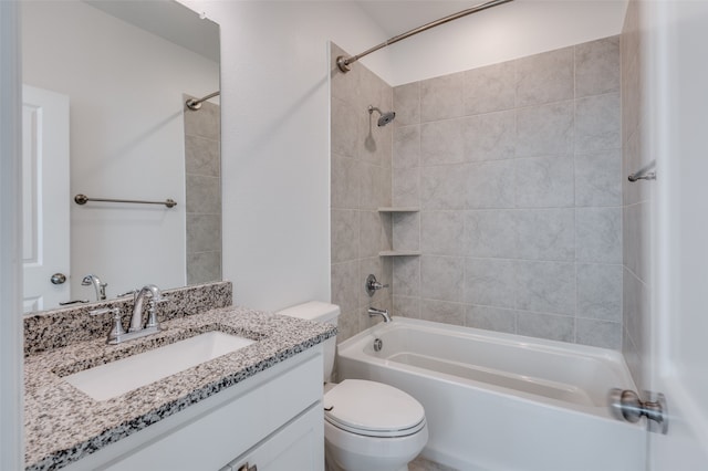 full bathroom featuring tiled shower / bath, vanity, and toilet