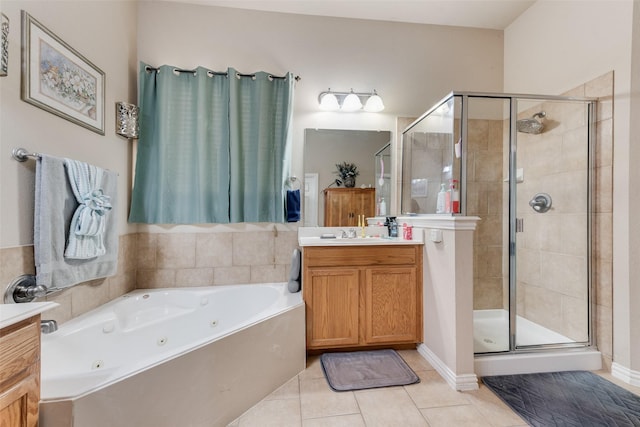 bathroom with tile patterned flooring, vanity, and shower with separate bathtub