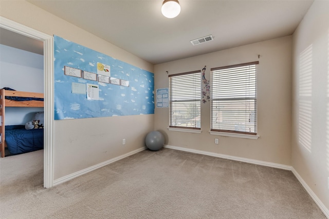 workout room with light colored carpet