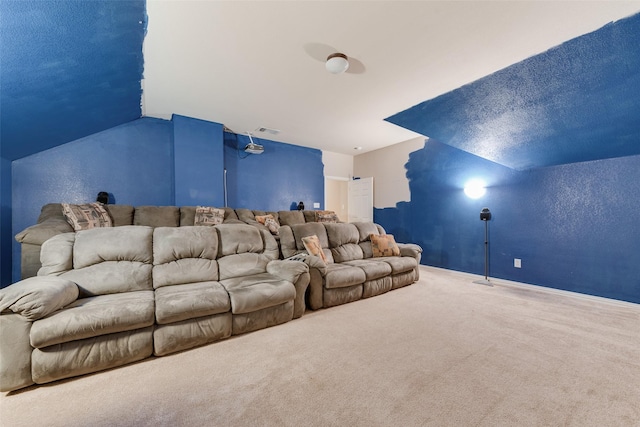 cinema room with a textured ceiling, carpet floors, and lofted ceiling