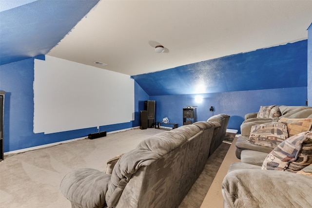 carpeted home theater featuring lofted ceiling