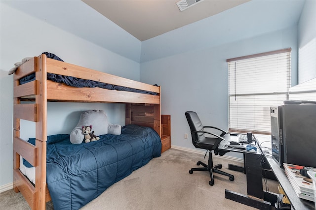 bedroom featuring light colored carpet and multiple windows