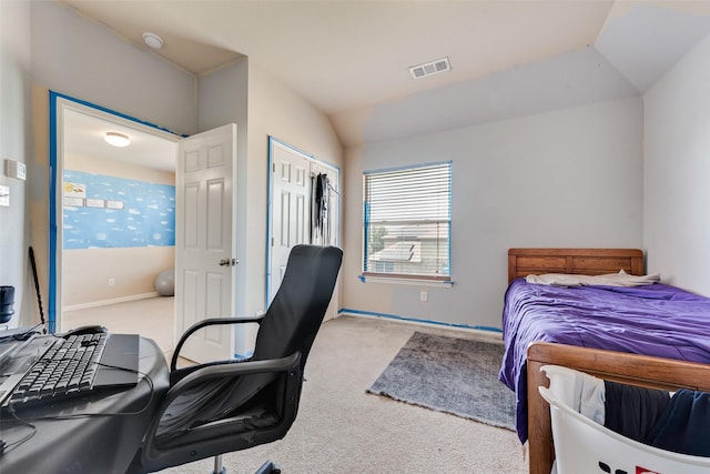 bedroom with light colored carpet and lofted ceiling