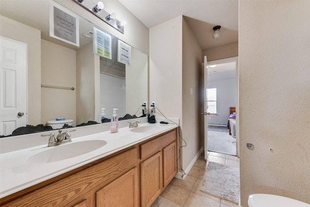 bathroom with tile patterned floors, vanity, and toilet