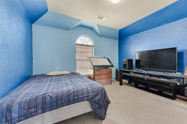 carpeted bedroom with vaulted ceiling