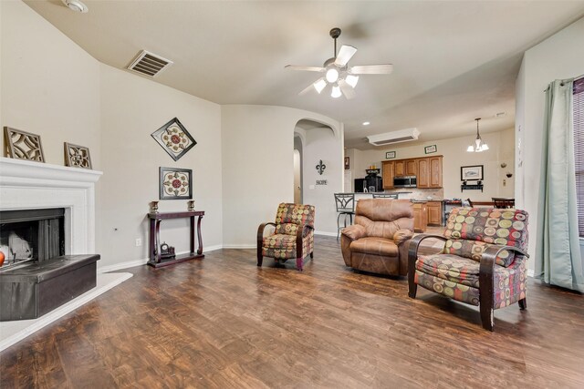 living room featuring ceiling fan and dark wood-type flooring