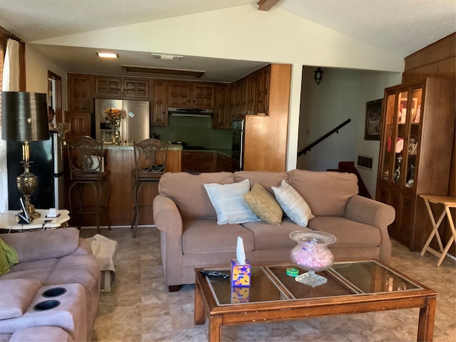 living room featuring lofted ceiling with beams