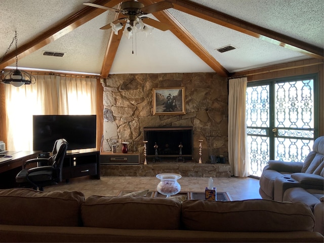 living room with a textured ceiling, ceiling fan, and plenty of natural light