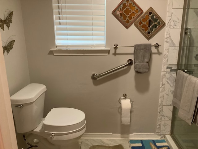 bathroom featuring an enclosed shower and toilet