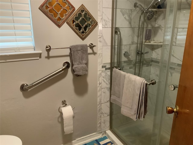 bathroom featuring a shower with door