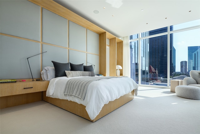 carpeted bedroom with a wall of windows