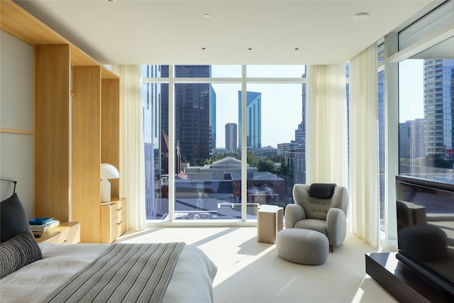 bedroom featuring multiple windows, a wall of windows, and carpet floors