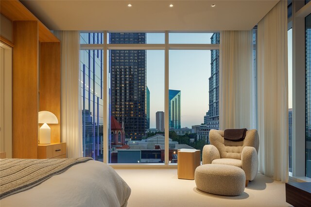 carpeted bedroom with floor to ceiling windows