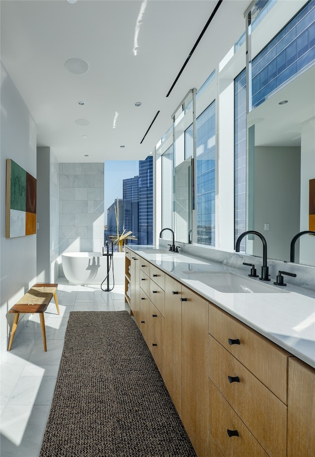 kitchen featuring light brown cabinetry, light tile patterned floors, and sink