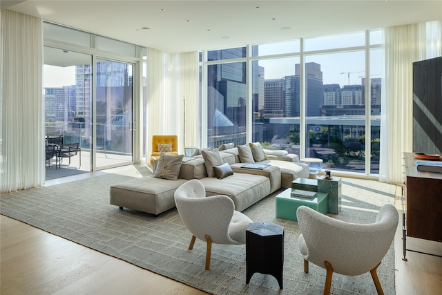 living room featuring a wall of windows, light hardwood / wood-style flooring, and plenty of natural light