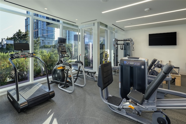 gym with a wall of windows