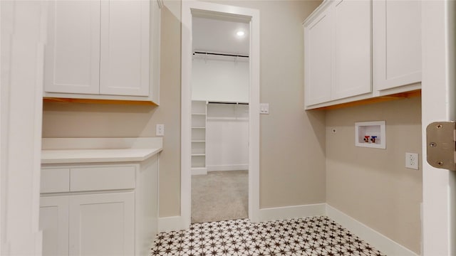 laundry room featuring hookup for a washing machine and cabinets