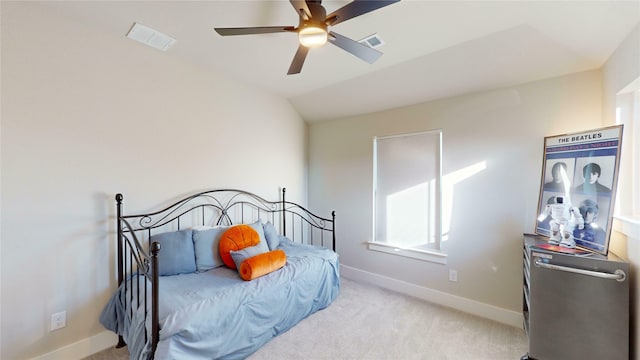 bedroom with ceiling fan, light colored carpet, and vaulted ceiling