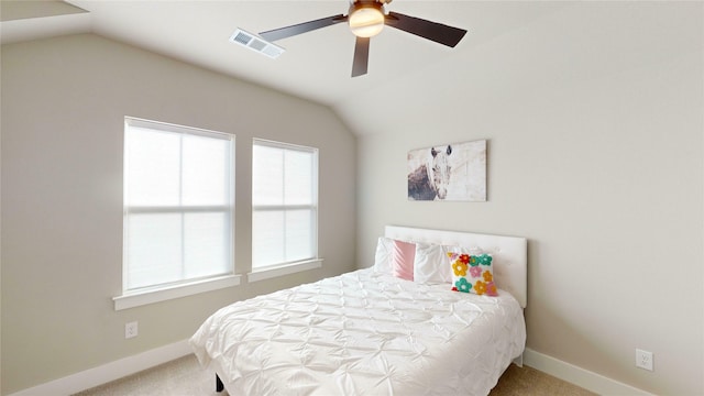 carpeted bedroom with vaulted ceiling and ceiling fan