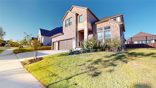 view of front of property featuring a front yard and a garage