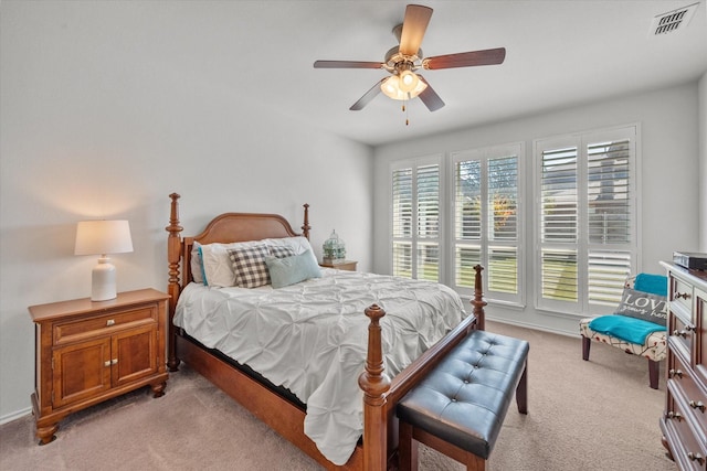 bedroom with ceiling fan and light carpet