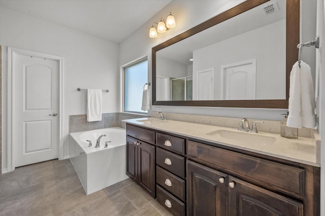 bathroom with vanity, tile patterned flooring, and shower with separate bathtub