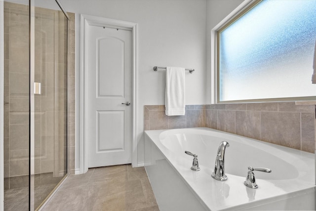 bathroom with tile patterned floors and independent shower and bath