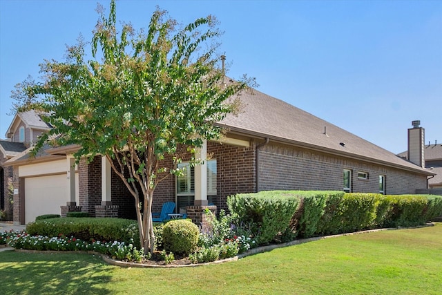 view of front of property featuring a front yard, a porch, and a garage