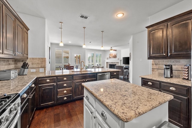 kitchen featuring tasteful backsplash, appliances with stainless steel finishes, sink, and dark brown cabinets