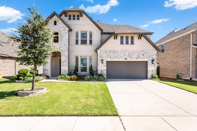 view of front of property with a garage and a front lawn