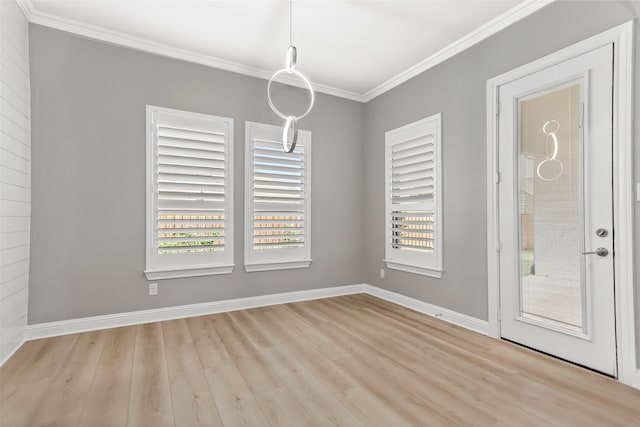 unfurnished dining area featuring light wood-type flooring and ornamental molding