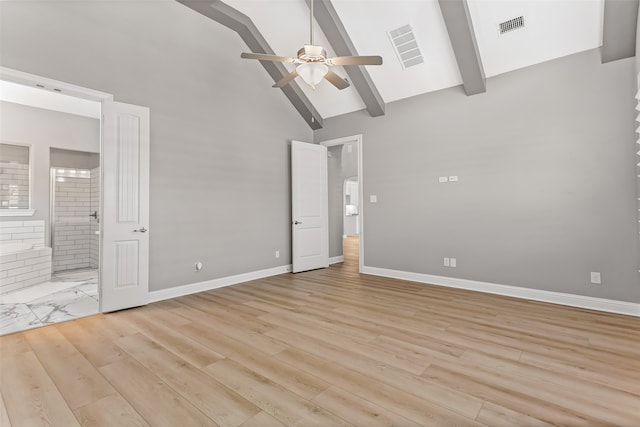 unfurnished bedroom with ceiling fan, beamed ceiling, connected bathroom, high vaulted ceiling, and light hardwood / wood-style floors