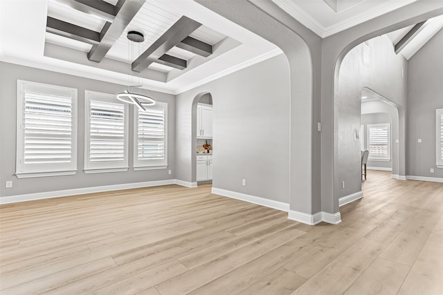 spare room featuring coffered ceiling, light hardwood / wood-style flooring, beam ceiling, and ornamental molding