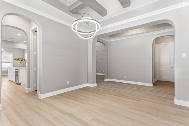 unfurnished dining area featuring ornamental molding, an inviting chandelier, and light hardwood / wood-style floors