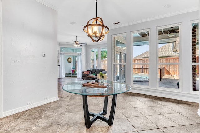 interior space featuring light tile patterned flooring, ornamental molding, and ceiling fan with notable chandelier