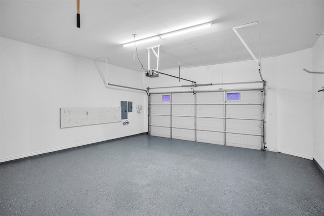 garage with electric panel and a garage door opener