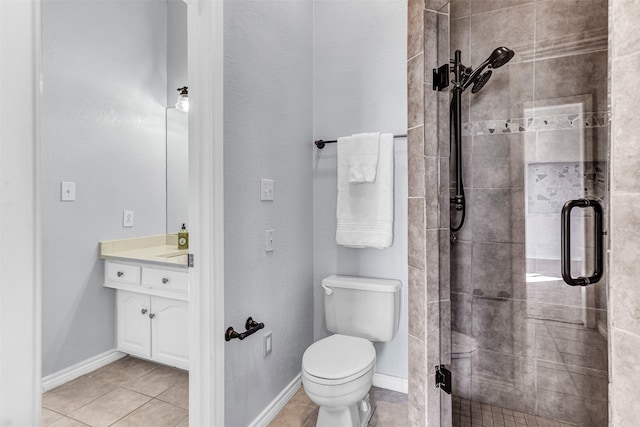 bathroom featuring tile patterned flooring, an enclosed shower, vanity, and toilet