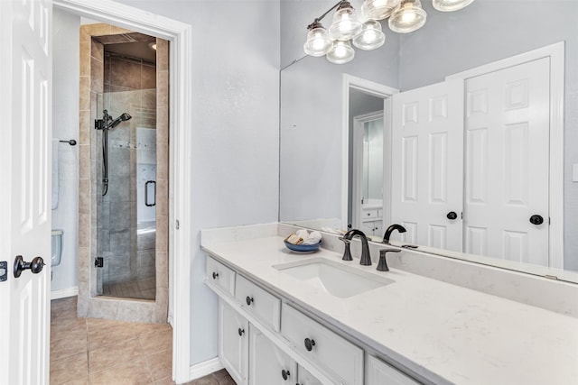 bathroom featuring tile patterned flooring, vanity, and a shower with shower door