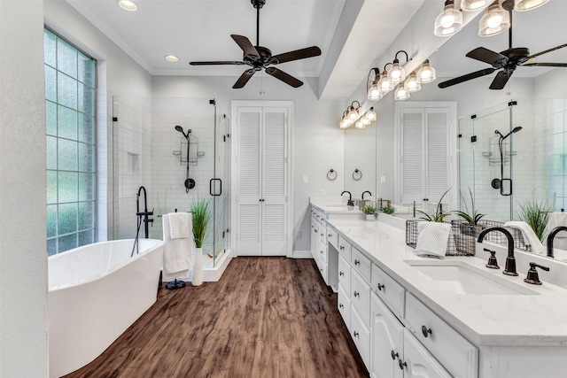 bathroom with vanity, hardwood / wood-style flooring, ornamental molding, and separate shower and tub