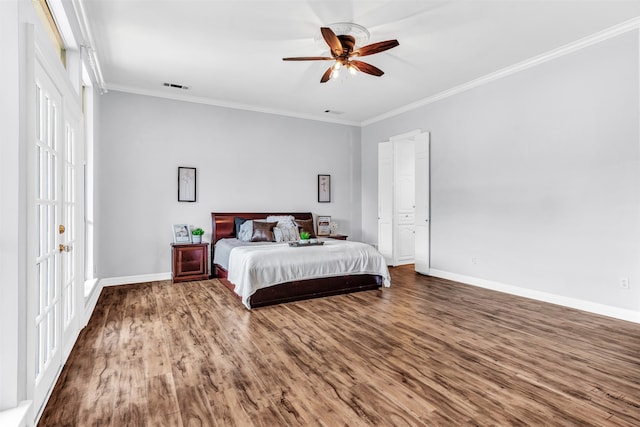 bedroom featuring ornamental molding, hardwood / wood-style floors, and ceiling fan