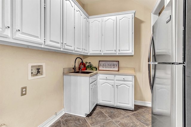 clothes washing area featuring cabinets, washer hookup, and sink