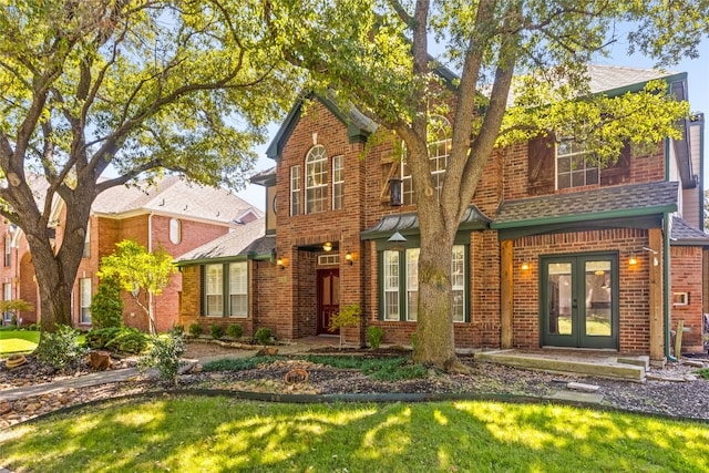 view of front of home with french doors and a front yard