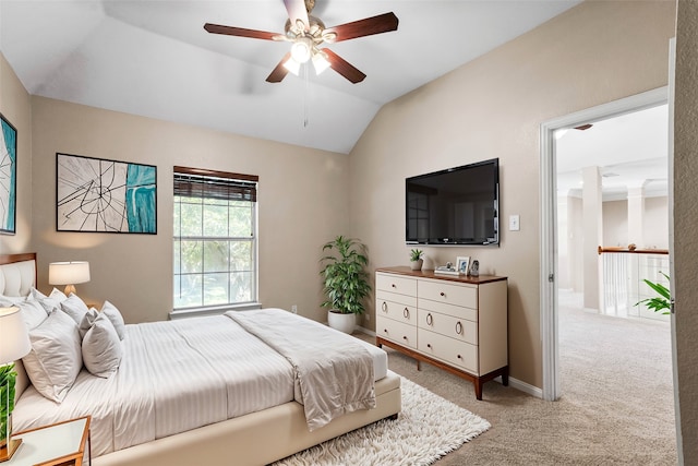 carpeted bedroom with vaulted ceiling and ceiling fan